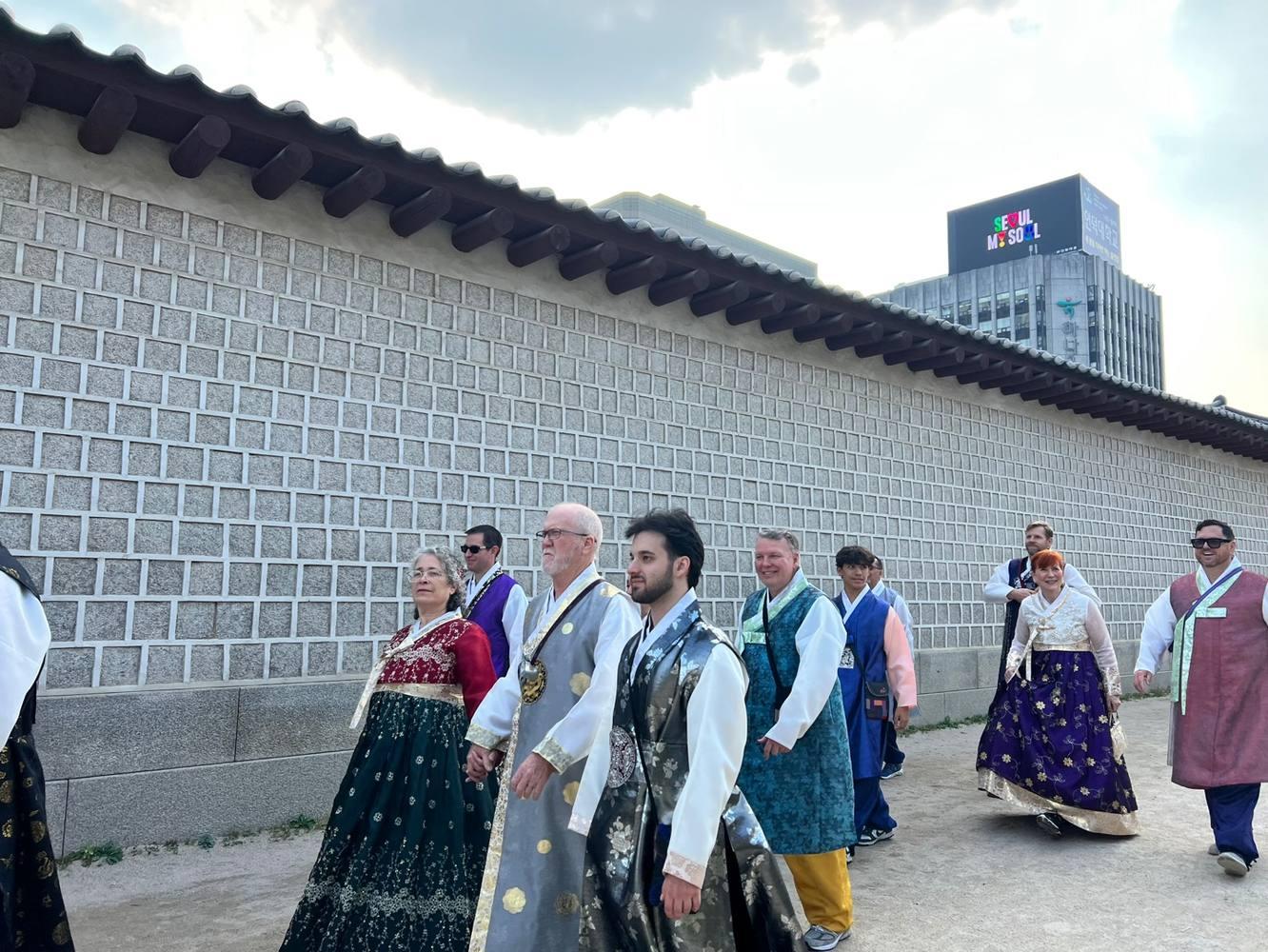 Walking by historic palace walls in hanbok